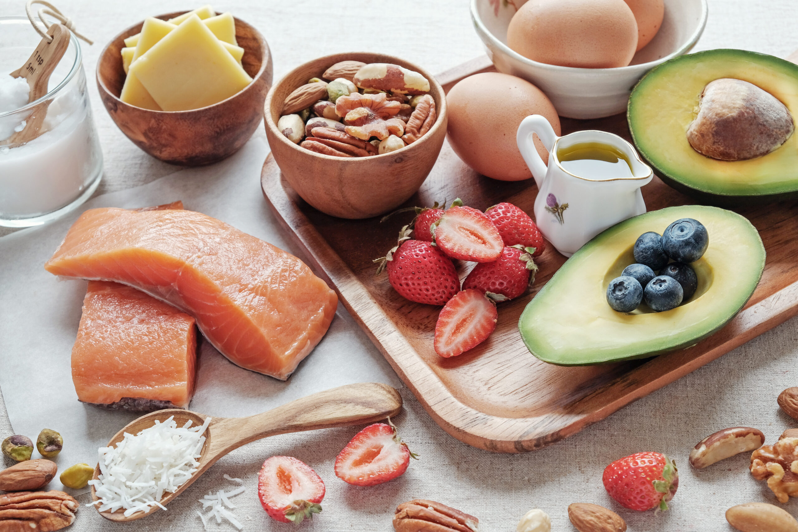 Protein-rich whole foods including salmon, eggs, cheese, nuts, avocado and berries